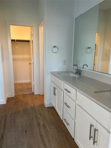 a bathroom with a sink a large mirror and a bathtub