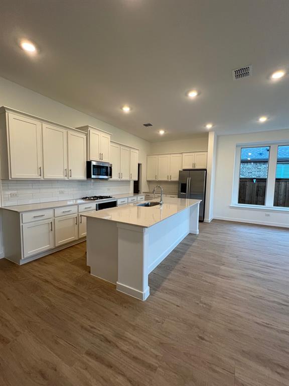 148 Breeds Hl Road Little Elm, TX 75068 - Photo 5 of 20 a large kitchen with a center island and stainless steel appliances