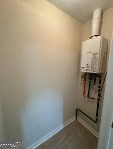 a view of kitchen with refrigerator and window