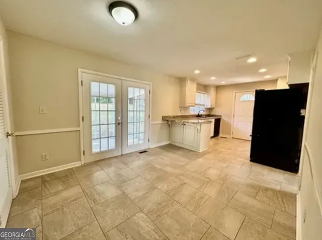 a view of a kitchen with a sink and a refrigerator