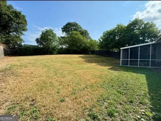 a view of a house with backyard and porch