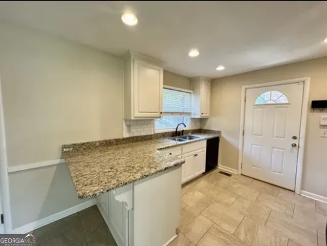 a kitchen with a refrigerator and a sink