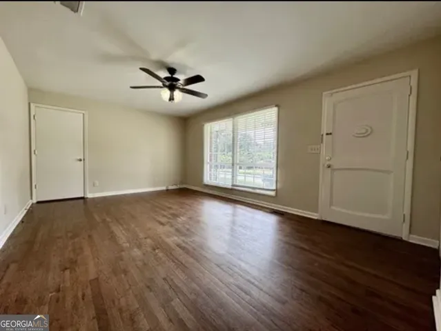 wooden floor in an empty room with a window