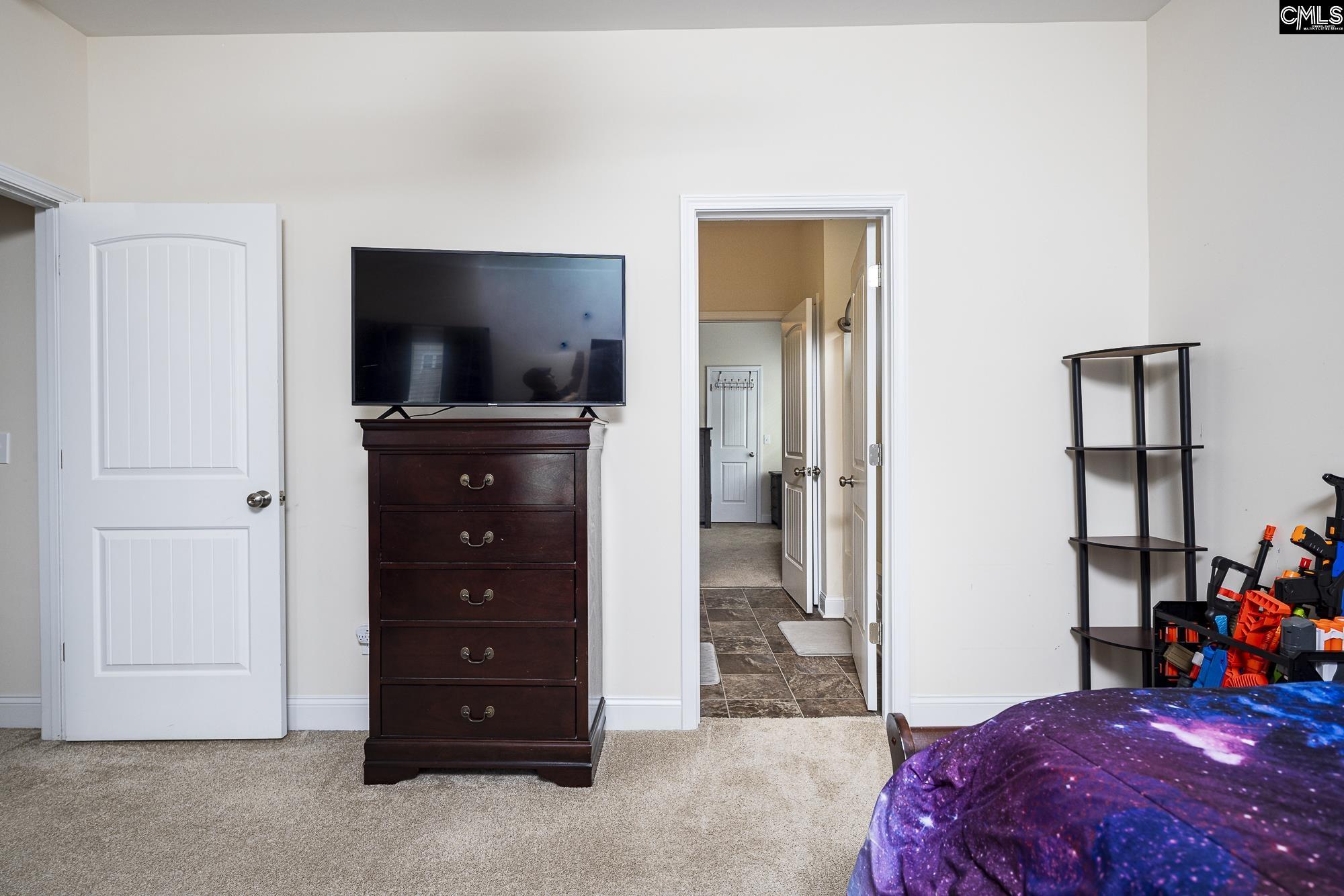 213 Sunset Point Drive Lexington, SC 29072 - Photo 26 of 35 a bedroom with a bed and a television