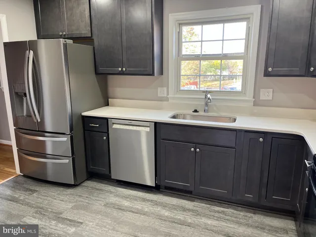 a kitchen with a sink and a refrigerator