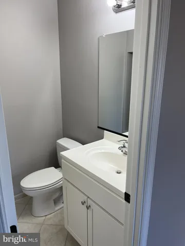 a white toilet sitting next to a white sink