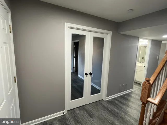 hallway with wooden floor and stairs