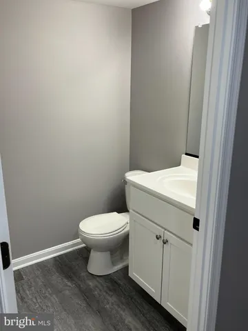 a white toilet sitting next to a white cabinet