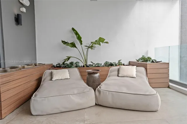 a living room with furniture and flowers
