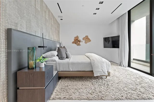 a bed room with a bed and a television