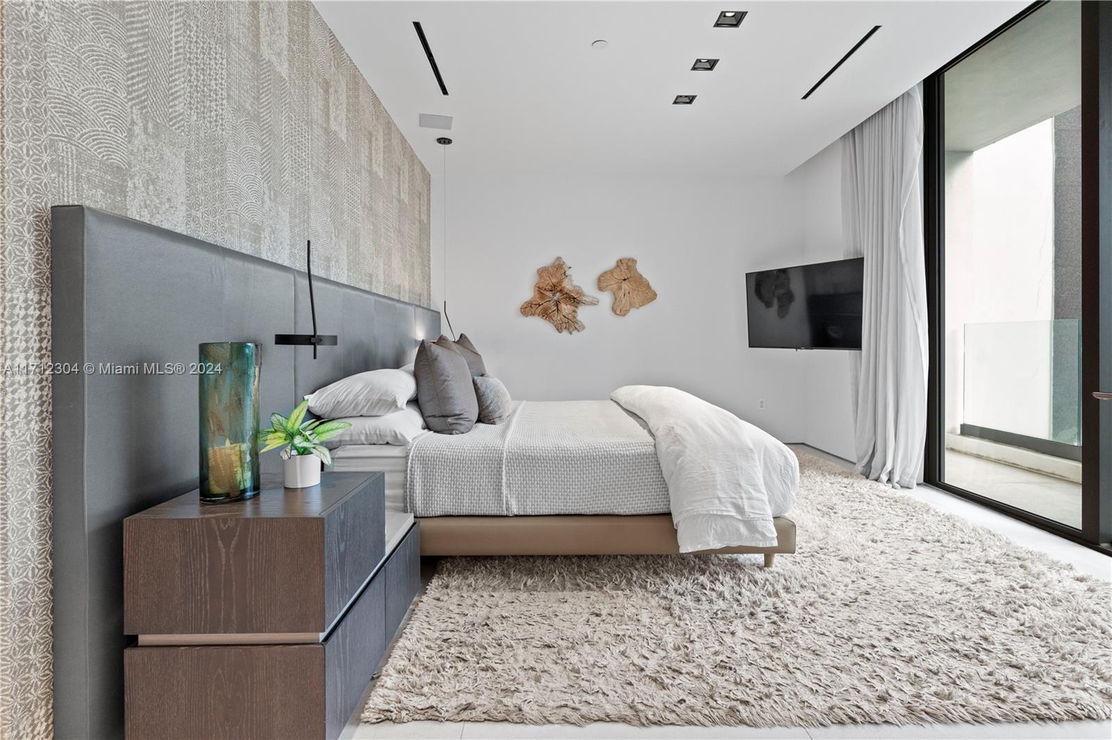 650 Northeast 32nd Street, Unit BH2 Miami, FL 33137 - Photo 17 of 30 a bed room with a bed and a television