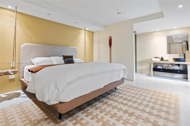 a bedroom with double bed and a couch