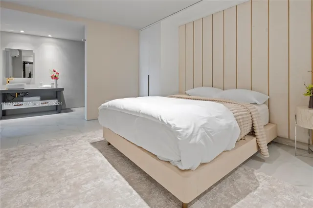 a bed room with a bed and a chair