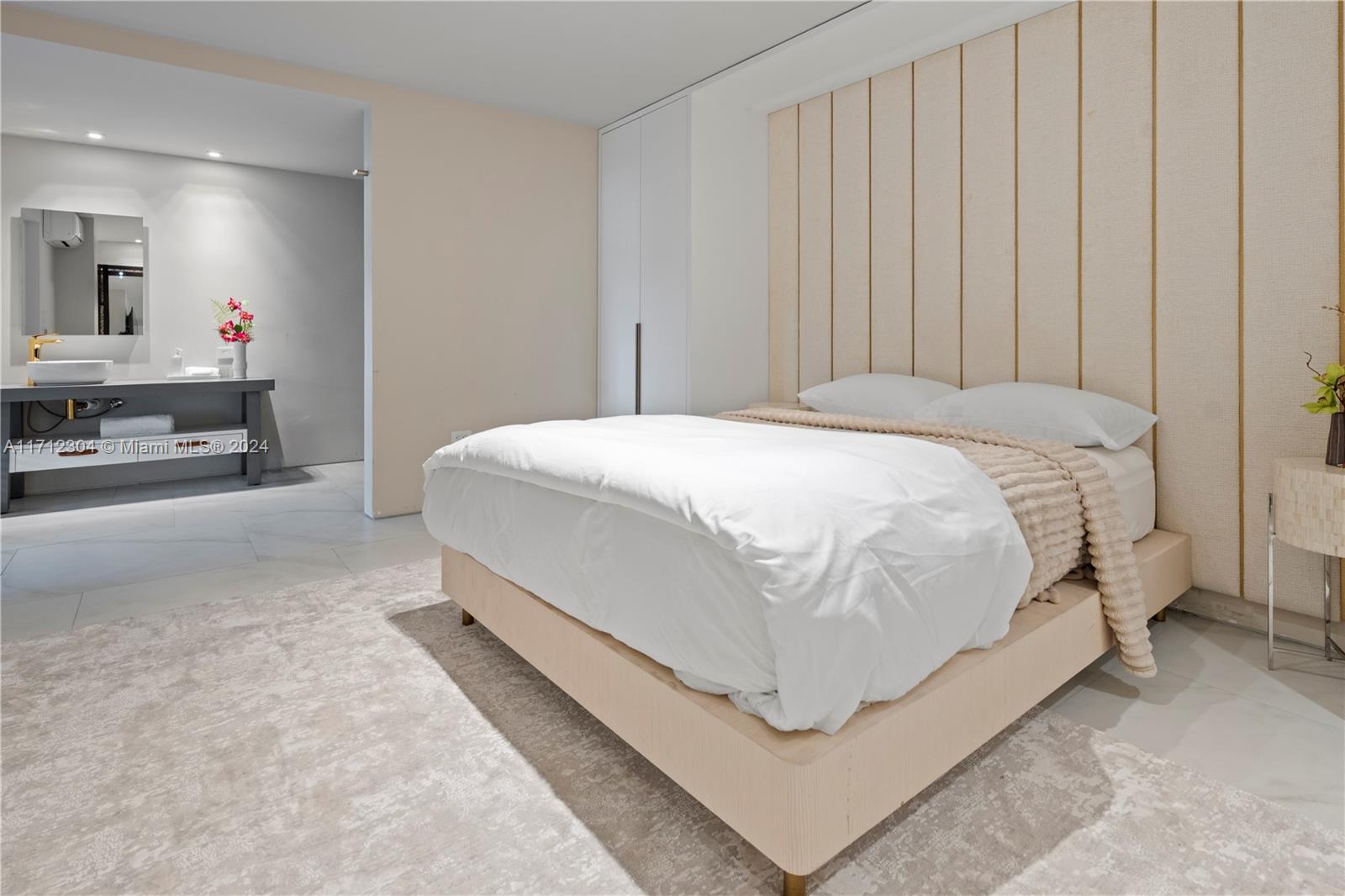 650 Northeast 32nd Street, Unit BH2 Miami, FL 33137 - Photo 27 of 30 a bed room with a bed and a chair