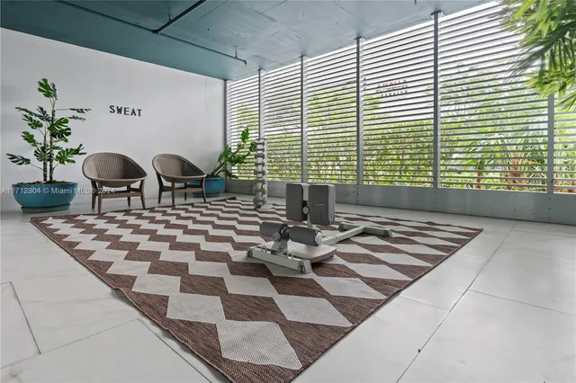 a view of a room with wooden floor and furniture