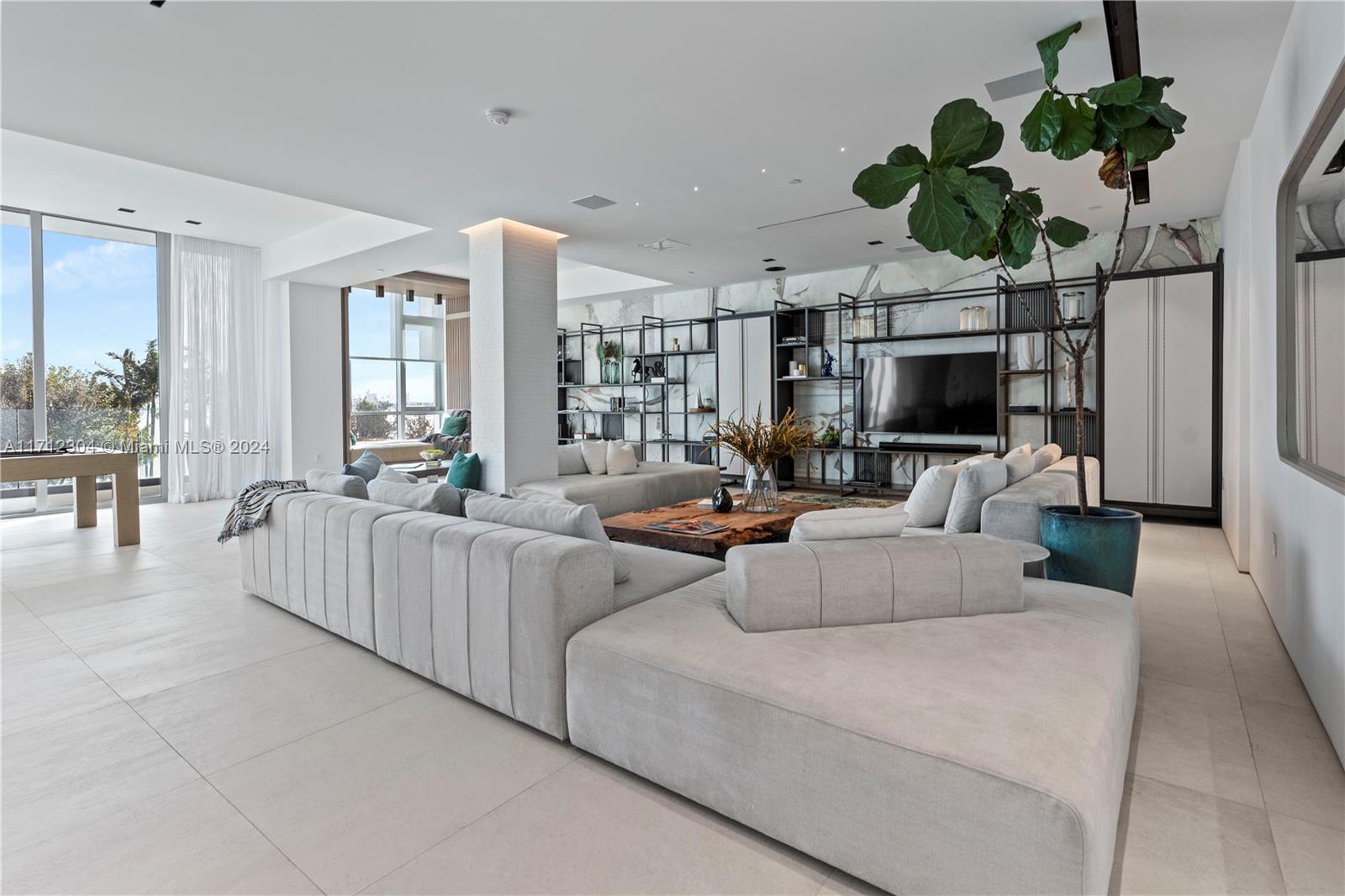 650 Northeast 32nd Street, Unit BH2 Miami, FL 33137 - Photo 3 of 30 a living room with fireplace furniture and a potted plant