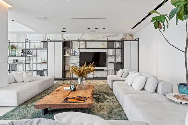 a living room with furniture fireplace and a table