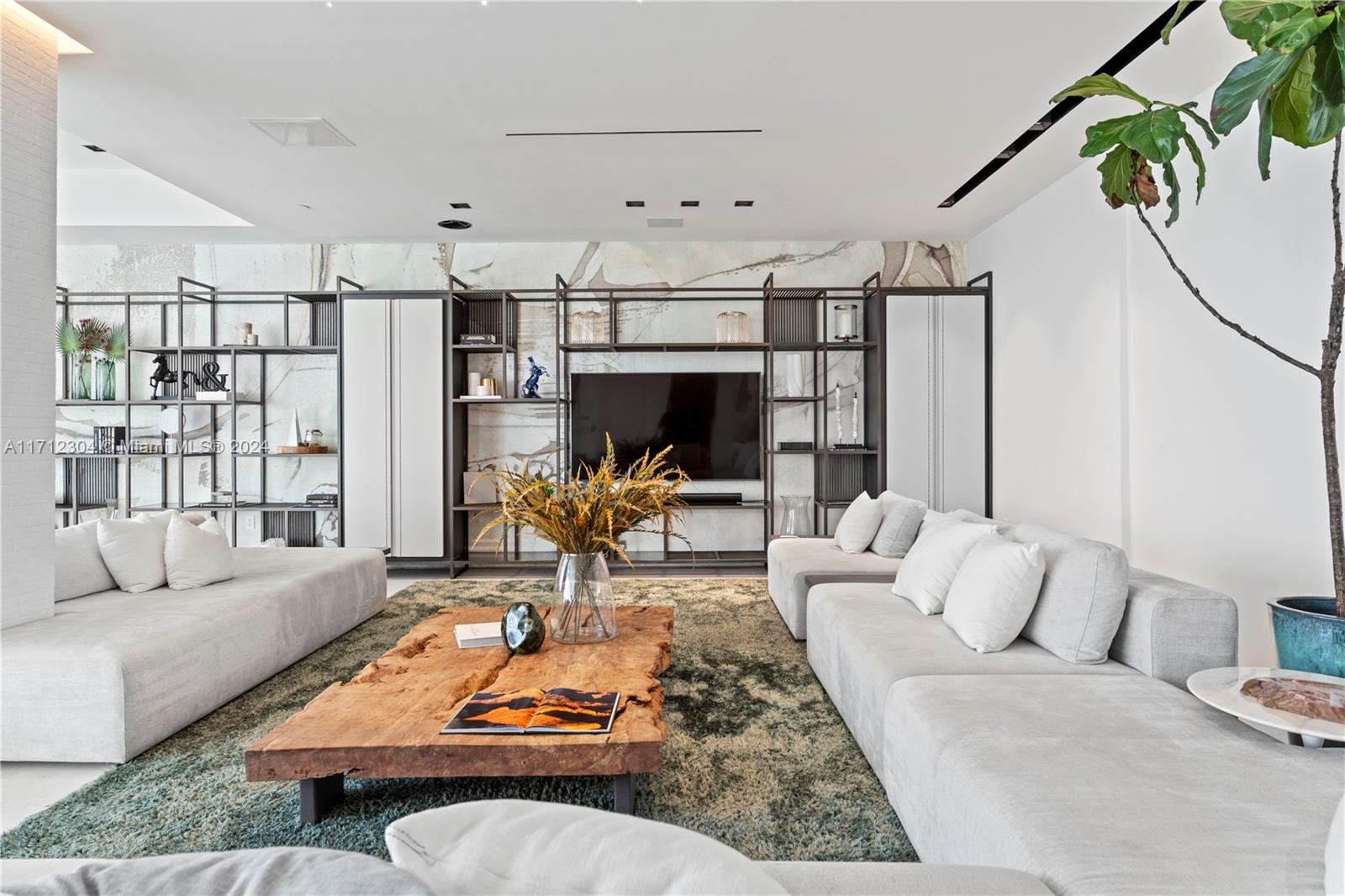 650 Northeast 32nd Street, Unit BH2 Miami, FL 33137 - Photo 4 of 30 a living room with furniture fireplace and a table