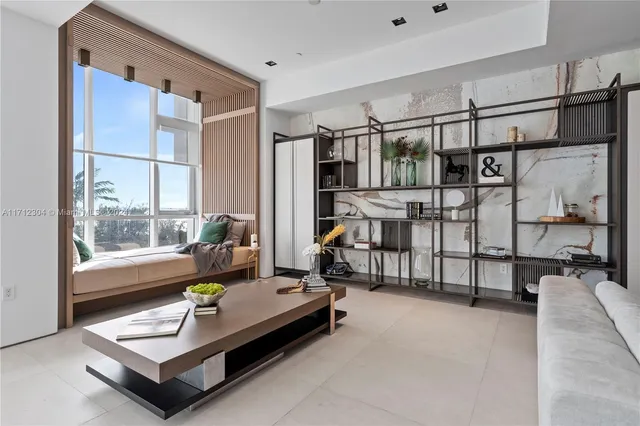 a living room with furniture a flat screen tv and a large window