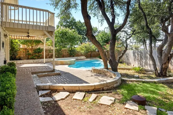 a view of backyard with wooden fence
