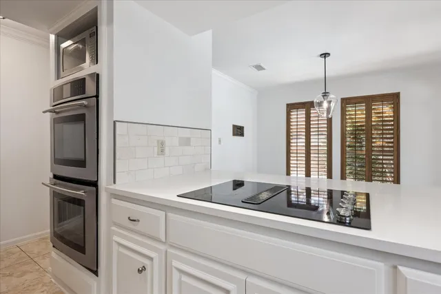 a kitchen with stainless steel appliances a refrigerator sink and cabinets
