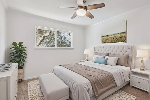 a bed sitting in a bedroom next to a window