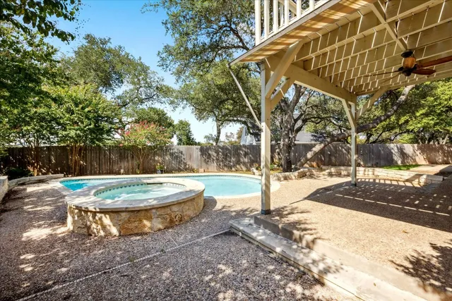 a swimming pool with outdoor seating and yard