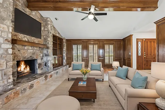 a view of an empty room with a fireplace and a window