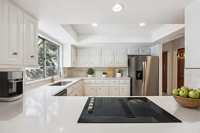 a kitchen with a refrigerator and a sink