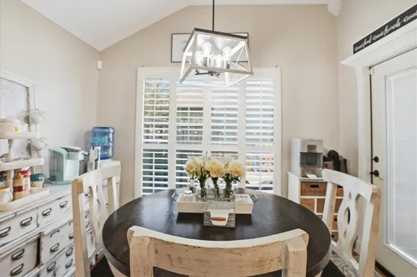 a view of a dining room with furniture and chandelier