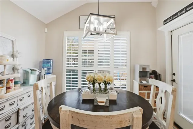 a view of a dining room with furniture and chandelier