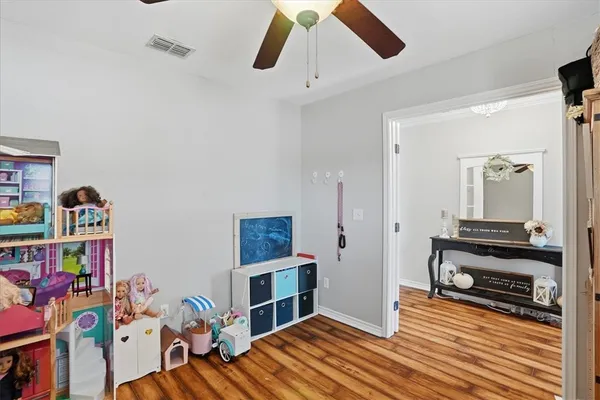 a bedroom with furniture and a book shelf