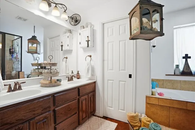a bathroom with a sink a mirror and vanity