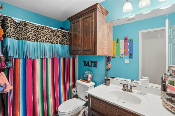 a bathroom with a sink toilet and a mirror