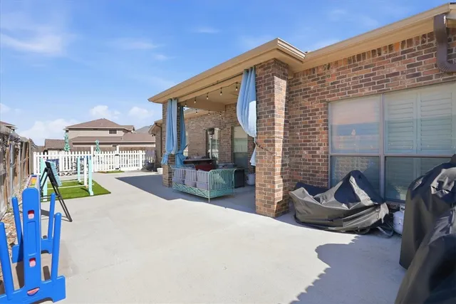 a view of a house with backyard porch and sitting area