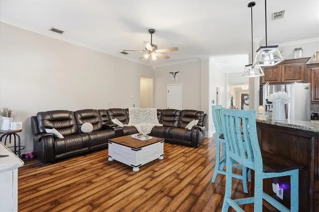 a living room with furniture a flat screen tv and a fireplace