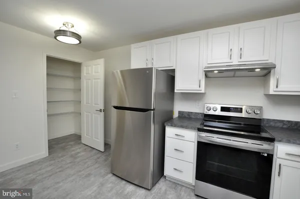 a kitchen with cabinets and stainless steel appliances