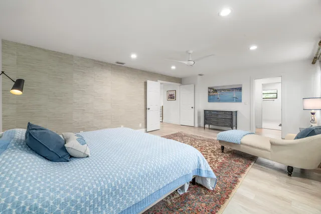 a spacious bedroom with a bed and a couch