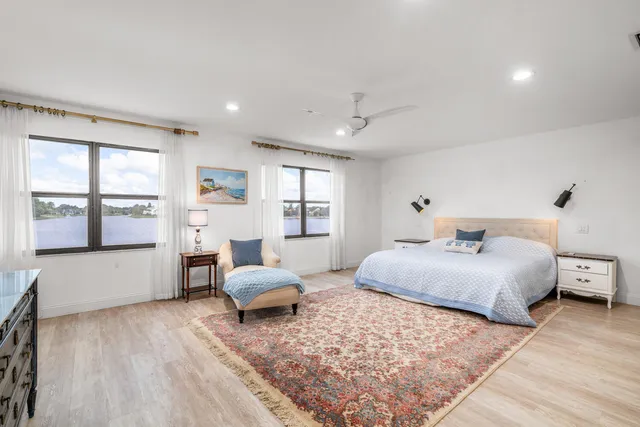 a bedroom with a bed and large window