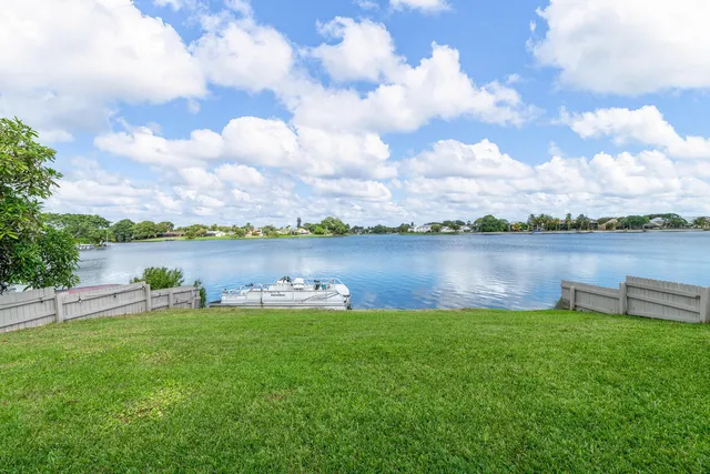 a view of a lake with houses in the back