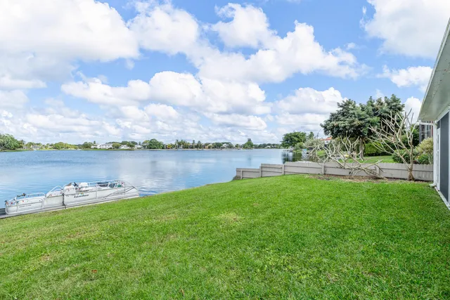 an aerial view of a house with outdoor space and lake view