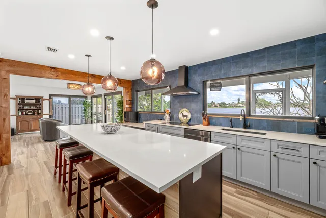 a kitchen with a table chairs and a large window