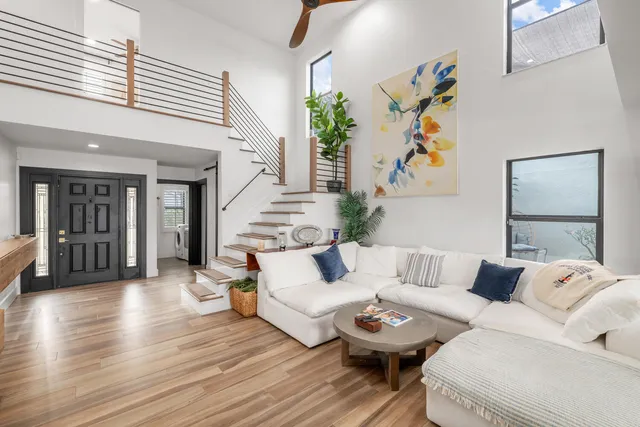 a living room with furniture and wooden floor