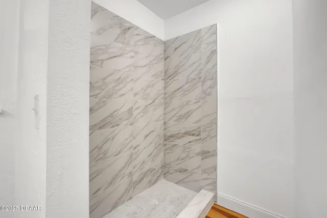 an empty room with a window and a ceiling fan