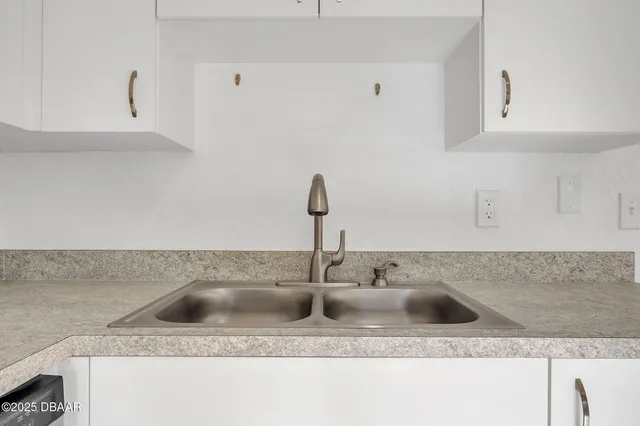 a kitchen with sink and granite