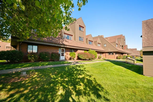 a front view of house with yard and green space