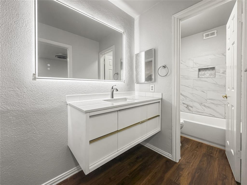 5840 Spring Valley Road, Unit 1104 Dallas, TX 75254 - Photo 14 of 16 Floating vanity with a white countertop and integrated sink