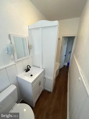 a bathroom with a toilet sink and mirror