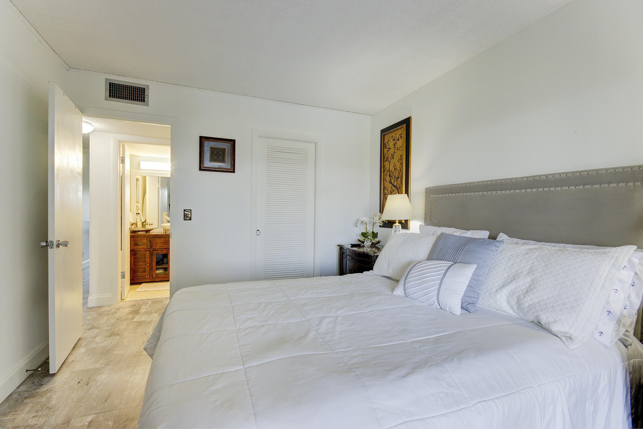 363 Wellington J West Palm Beach, FL 33417 - Photo 11 of 17 a bedroom with a bed and a mirror