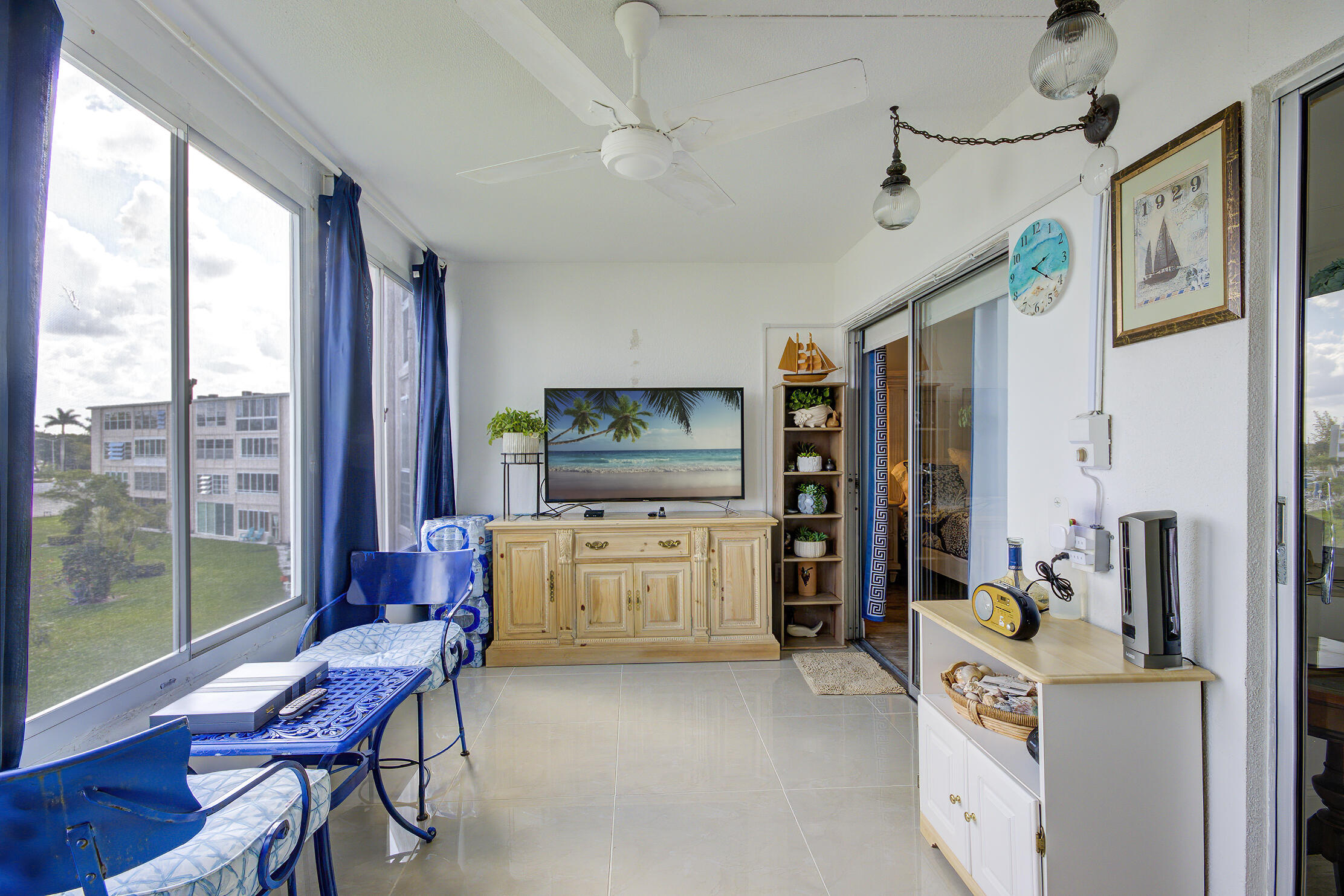 363 Wellington J West Palm Beach, FL 33417 - Photo 15 of 17 a room with furniture a flat screen tv and a window